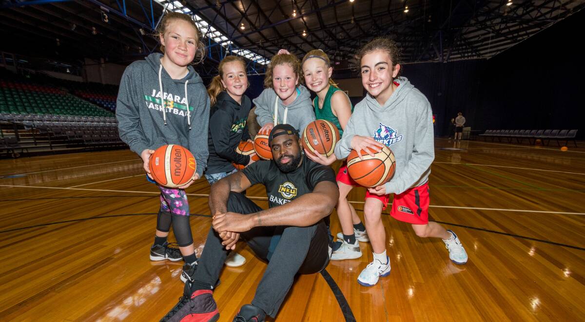 OUR HERO: Southern Huskies import Jalen Billups with basketball hopefuls Lucy William, Matilda Neate, Ava Murfet, Ava Hawkins and Sophie Ryan during a holiday clinic at the Silverdome on Friday. Picture: Phillip Biggs