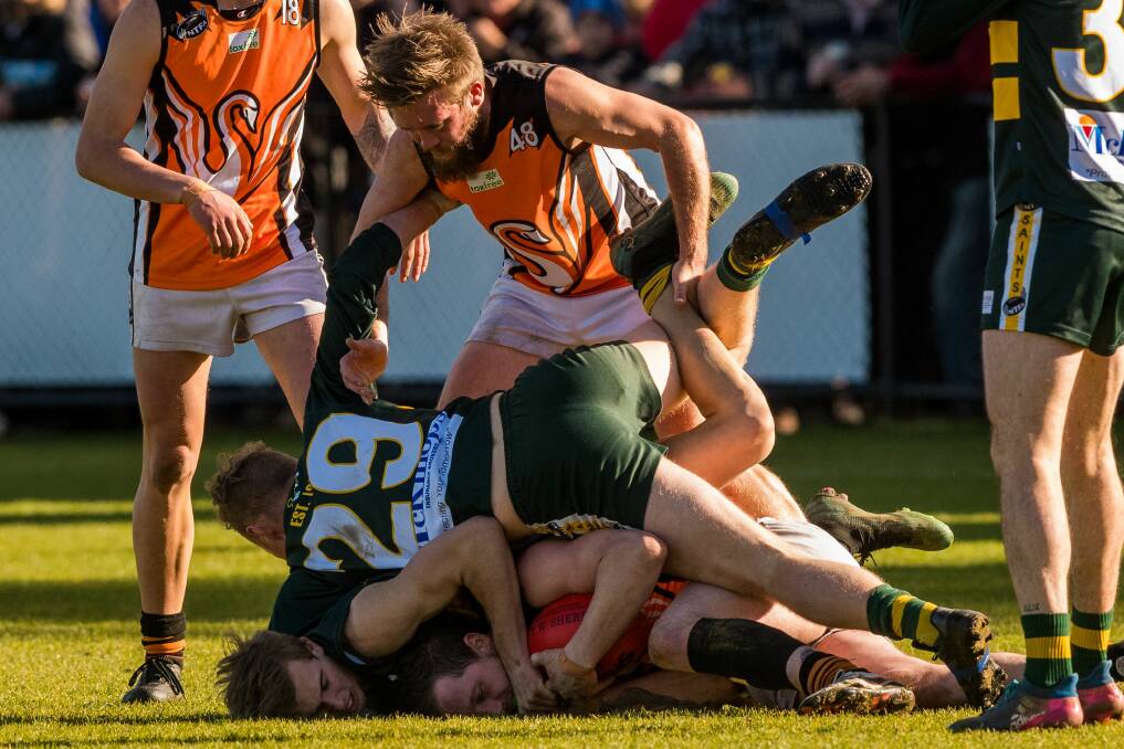 PILE ON: East Coast's Jeoff Connolly looks to pull St Pats' Tom Hilder off the pack.