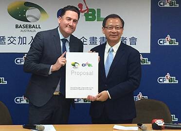 Baseball Australia boss Cam Vale exchanges documents with Chinese Professional Baseball League Commissioner John Wu. Picture: Baseball Australia