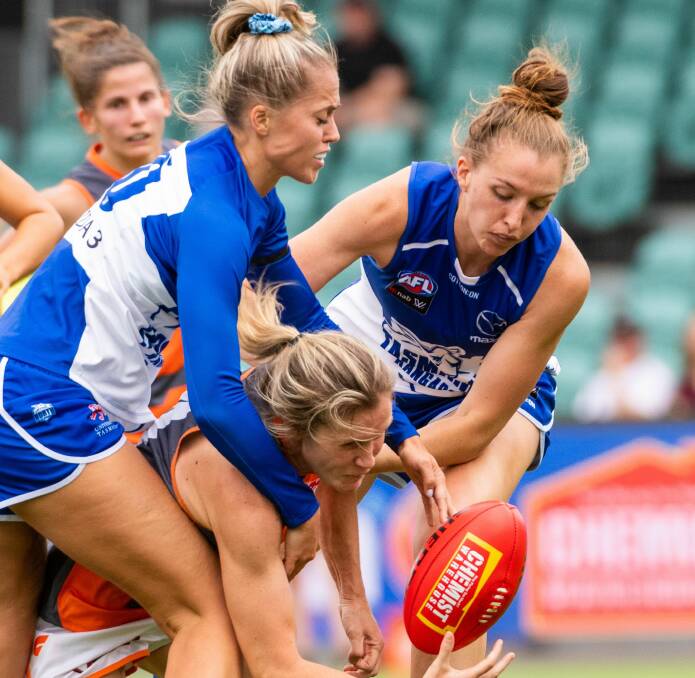 TAKE THIS: North Melbourne-Tasmanian Kangaroos harass GWS Giant Annalyse Lister in a gang tackle. 