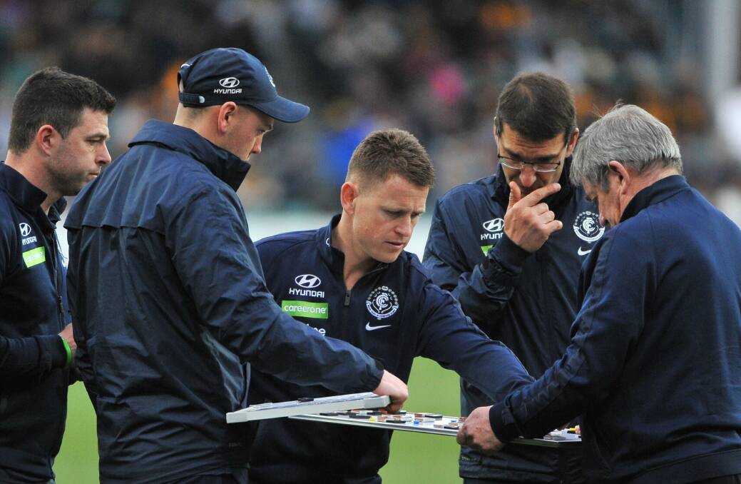 OUT OF THE BLUE: Carlton coach Brendon Bolton poignantly moves the magnets around the whiteboard during Carlton's last visit to UTAS Stadium. Picture: Scott Gelston