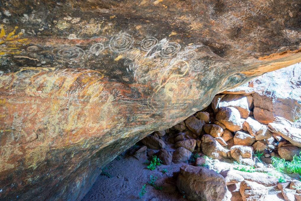 Indigenous rock paintings at the base of Uluru. Picture: Michael Turtle