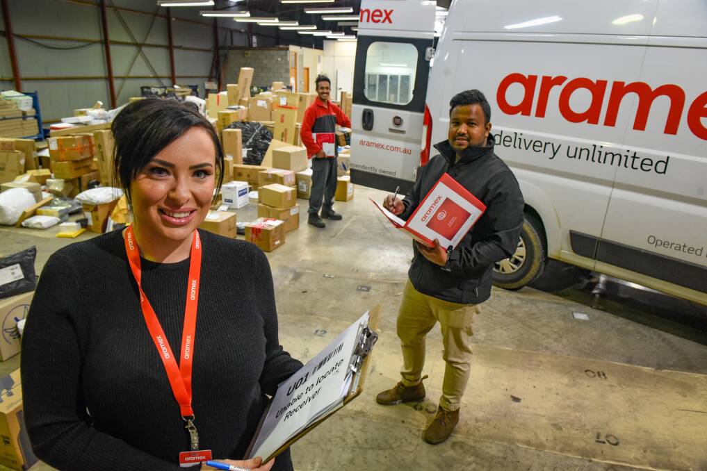 ON THE MOVE: General manager of Aramax Tasmania Hannah Bradley with courier Anoj Bhandari and regional franchise manager Samiul Islam at the company's new depot in Invermay. Picture: Paul Scambler.