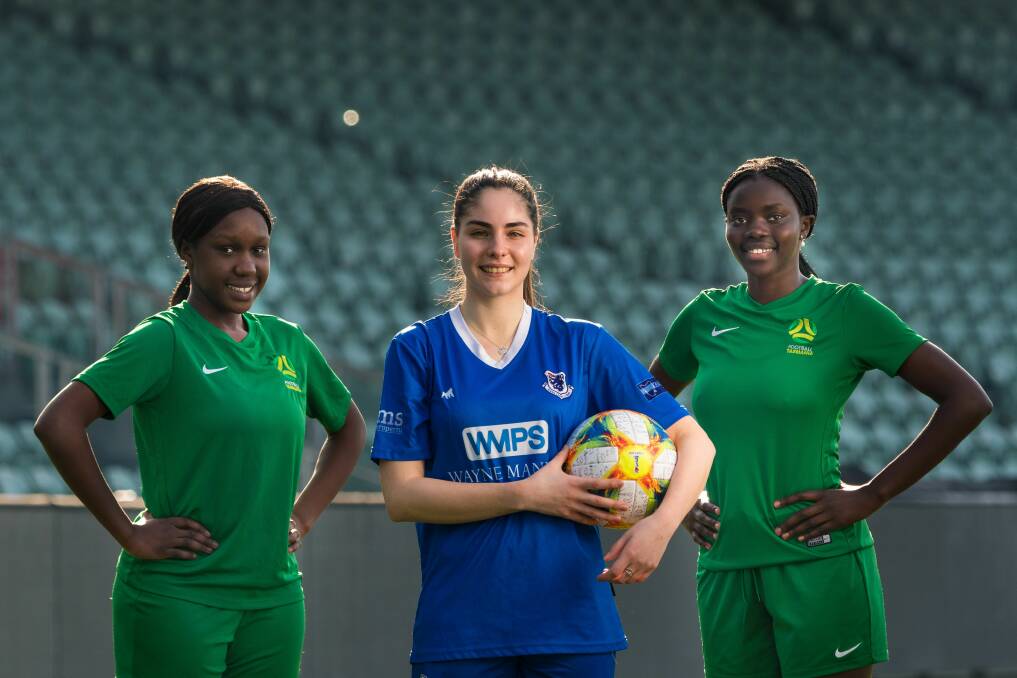 Taking to the field: Launceston United soccer players Gonya Luate, Jade Ruffo and Adilat Otto. Picture: Phillip Biggs