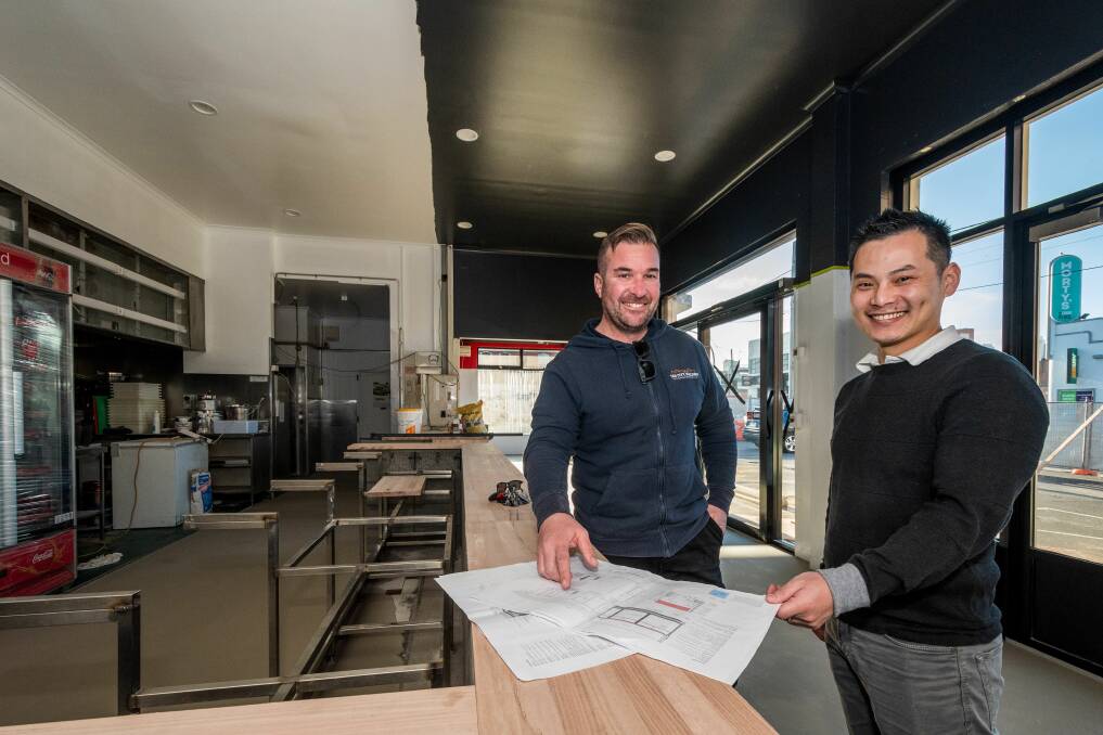TRANSFORMING ICON: Tas City Building director Steven Simeoni and The Original Charcoal Chicken shop owner Somba Lim and expect the popular eatery to be open within the next two weeks. Picture: Phillip Biggs
