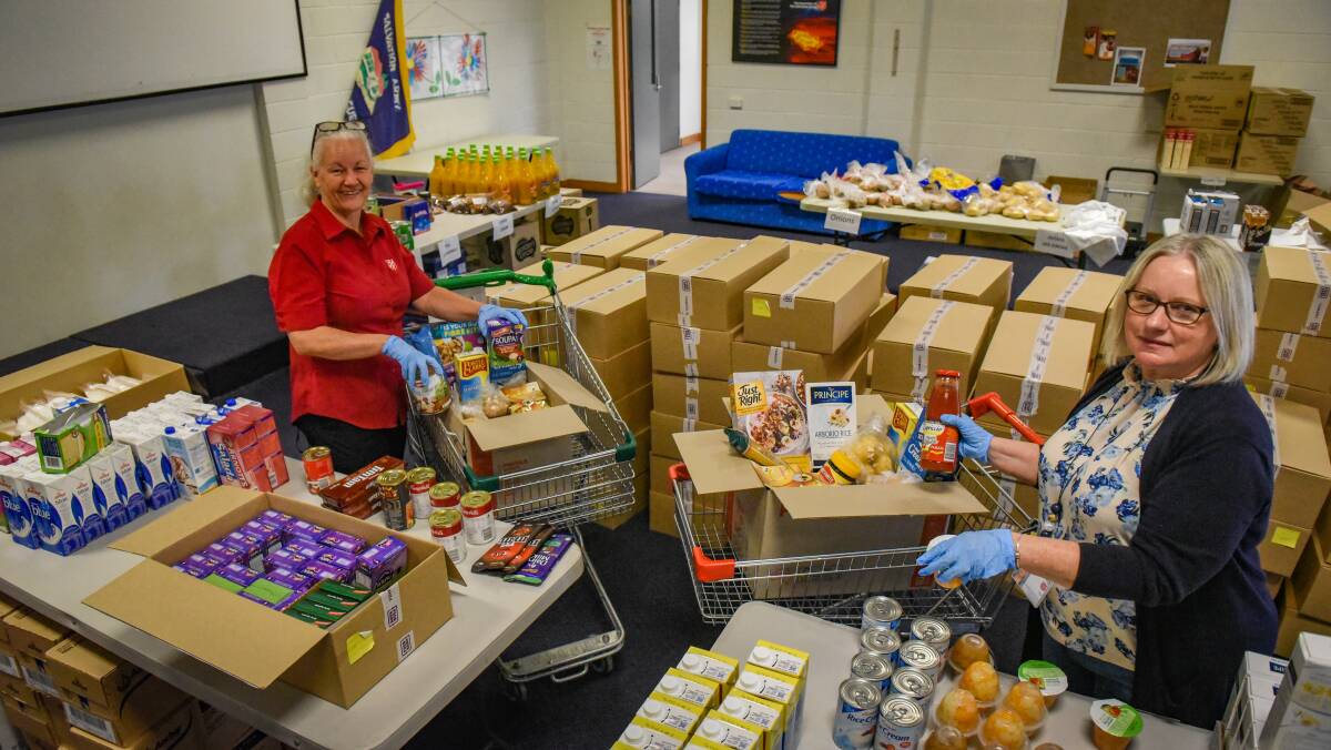 HELPING OUT: Salvation Army Captain Jacky Laing and outreach worker Sue Wynne pack hampers in Launceston for people in need during the coronavirus pandemic. Picture: Paul Scambler.