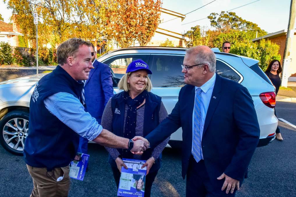 BEFORE SOCIAL DISTANCING: Former Premier Will Hodgman, Liberal candidate for Bass Bridget Archer and Prime Minister Scott Morrison in Launceston on election day in 2019. Picture: Neil Richardson