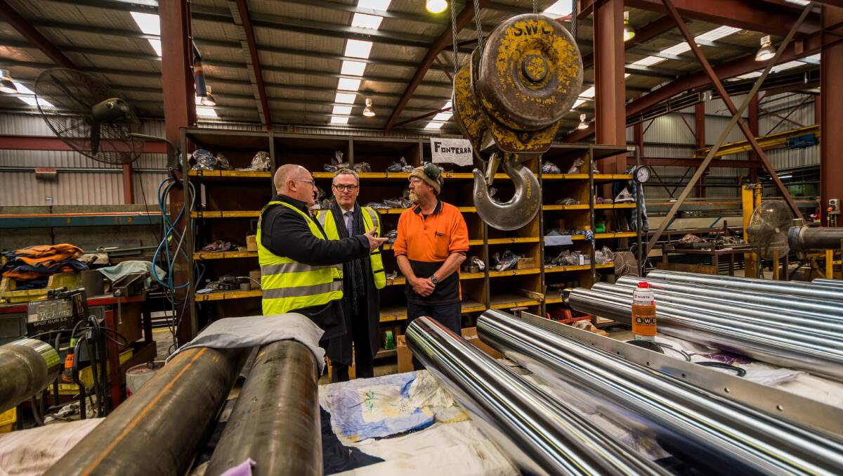 Power: Braddon Liberal candidate Brett Whiteley, Minster Christopher Pyne, and fitter Darren Murphy at Devonport defence industry company Delta Hydraulics. Picture: Phillip Biggs