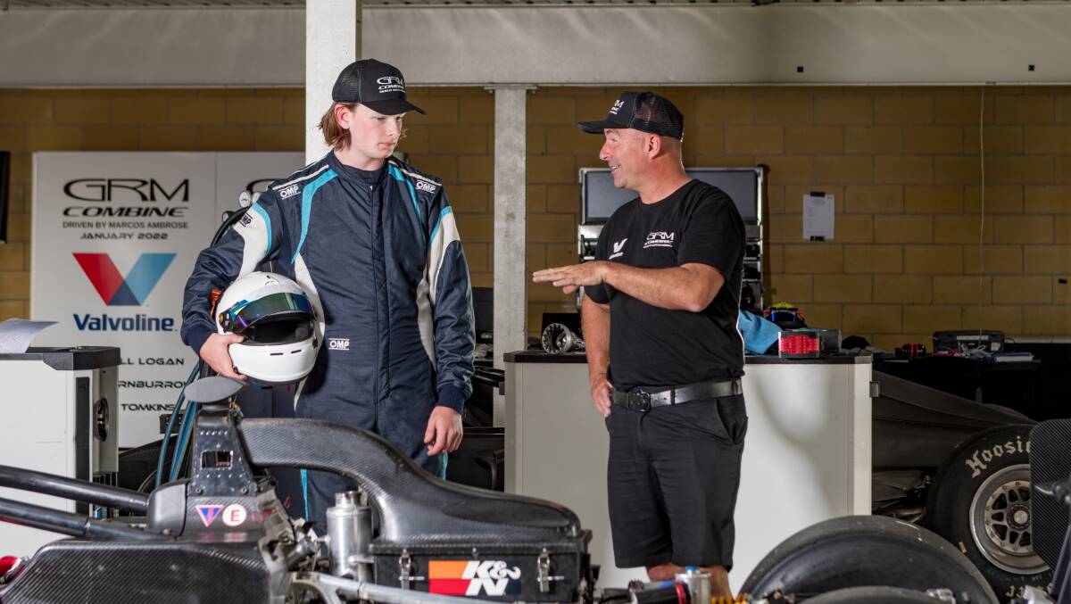 LISTENING CLOSELY: Tasmanian driver Campbell Logan soaks up knowledge from Supercars and NASCAR legend Marcos Ambrose. Picture: Phillip Biggs 
