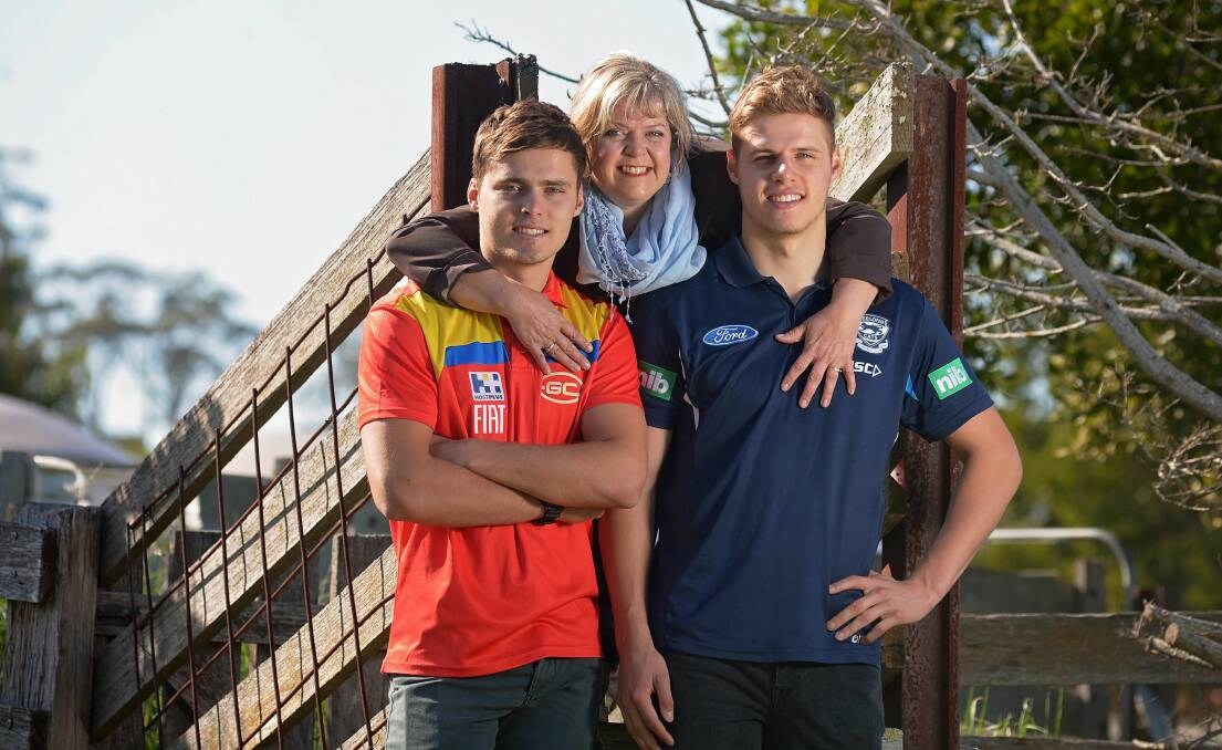 Twins Kade and Jake Kolodjashnij and their mum Sharon at their home near Longford in 2015. The brothers were drafted to the AFL in 2013. Picture by Phillip Biggs 
