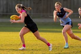 Queechy High School's Ava Murfet runs with the ball against Kings Meadows during the Bulldogs Cup at Youngtown Oval on Wednesday. Pictures by Phillip Biggs 