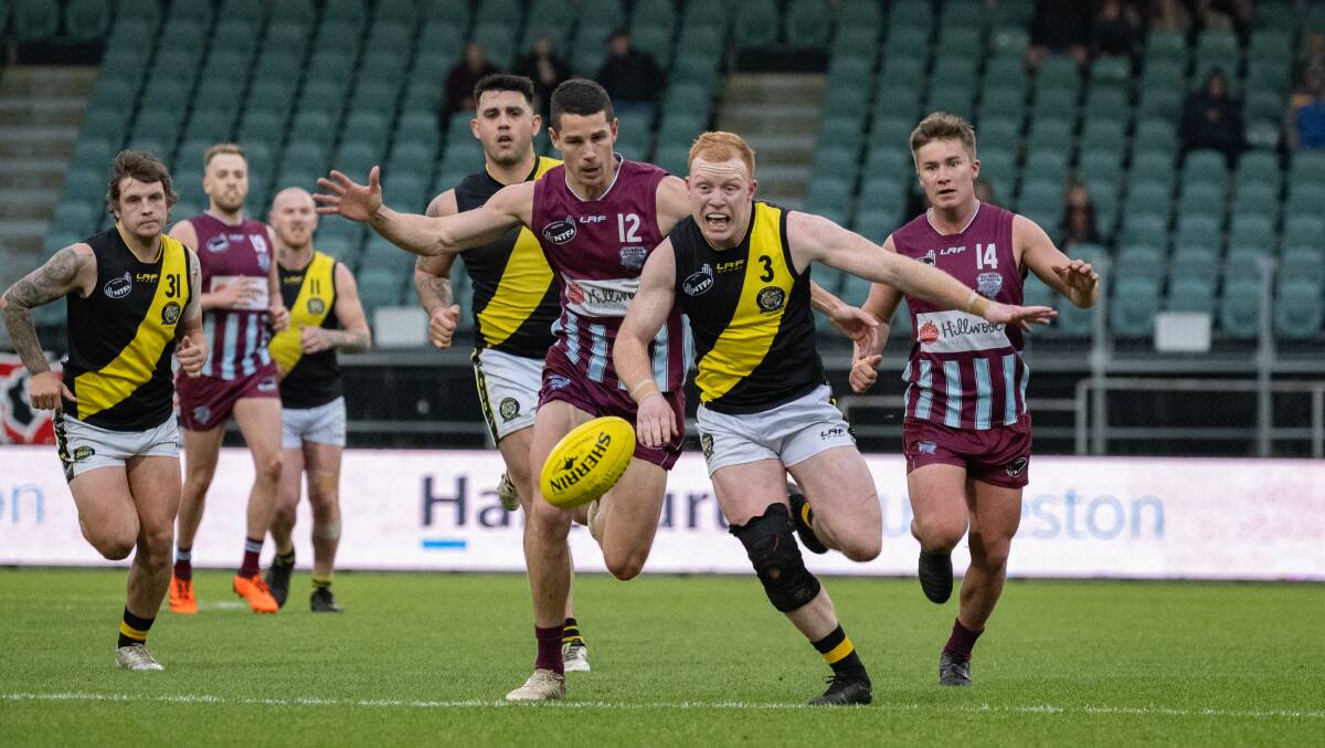 Hillwood's Jake Pearce chases Rocherlea's Jack Rushton during this year's NTFA premier grand final at UTAS Stadium. Pictures by Paul Scambler 