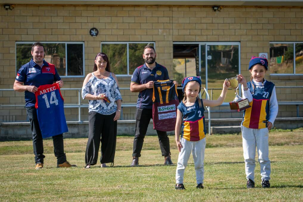 IMPORTANT MATCH: Keian Brown's nieces Brooklyn, 4, and Havana Crawford, 7, with the memorial cup watched by Brown's mum, Mel Roughley, Lilydale reserves playing-assistant Zach Deane and Old Scotch senior playing-assistant coach, John McKenzie. Pictures: Paul Scambler 