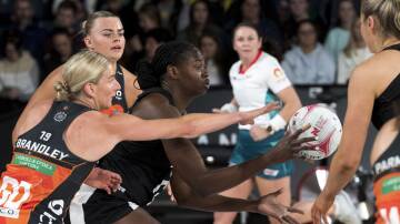 ENTERTAINING CONTEST: Collingwood goal shooter Shimona Nelson is defended by Giants goal defence April Brandley at the Silverdome. Picture: Phillip Biggs