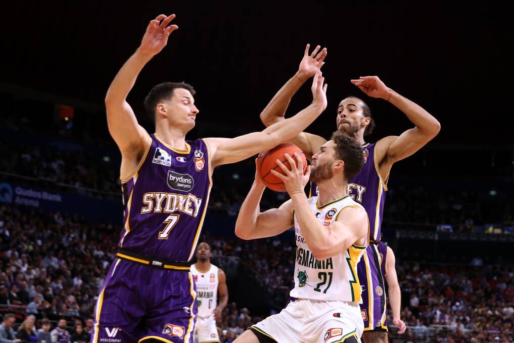 SURROUNDED: JackJumper Jarred Bairstow drives to the basket under pressure from Sydney Kings' Shaun Bruce and Xavier Cooks at Qudos Bank Arena. Picture: Jason McCawley/Getty Images