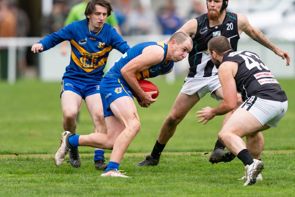 IN TRAFFIC: Evandale's Aidan Bullman gathers the ball under pressure from Perth opponents. 