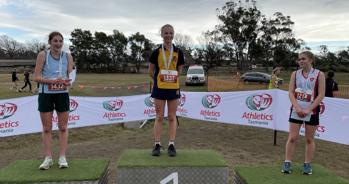 WELL DONE: St Mary's Jessica Smith, 15, Scotch Oakburn College's Sophie Marhsall, 15, and MacKillop College's Ariana Reeve, 15, on the podium after the under-16 girls' race. 