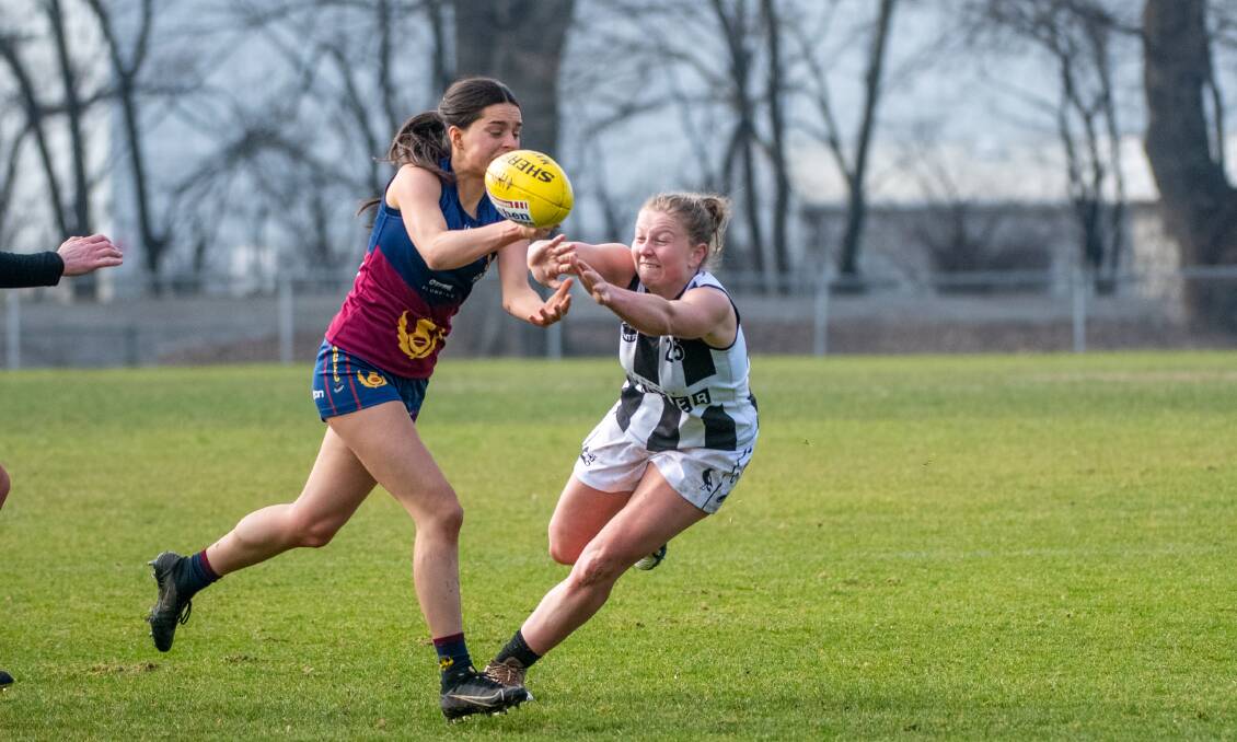 GALA DAY: Old Scotch's Eliane Fader and Scottsdale's Maddy Reid contest the ball at the NTCA ground in July. Both teams are playing at Youngtown on Saturday. Picture: Paul Scambler