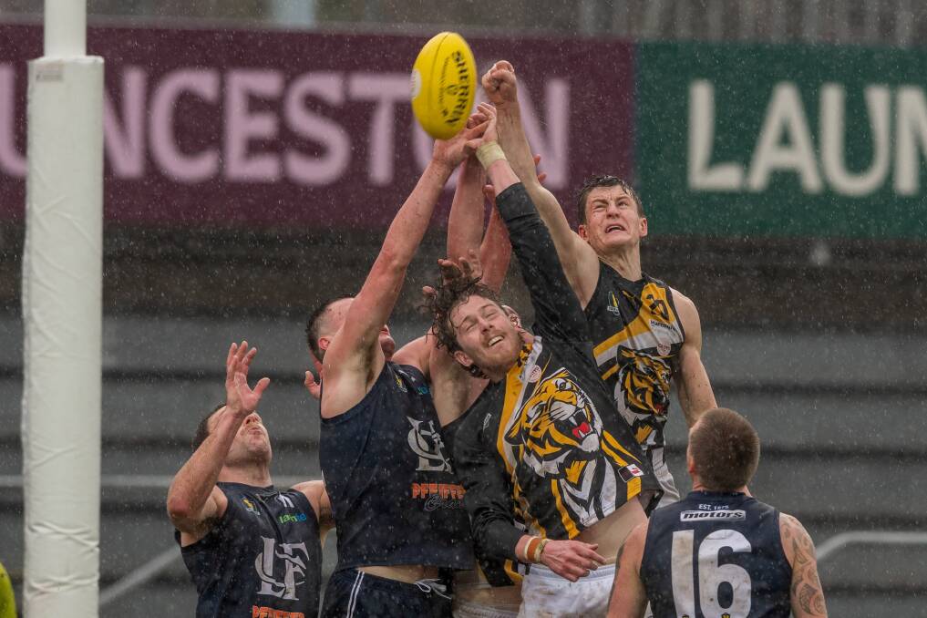 Kingborough's Zach Adams gets a fist to the ball during the grand final at UTAS Stadium.