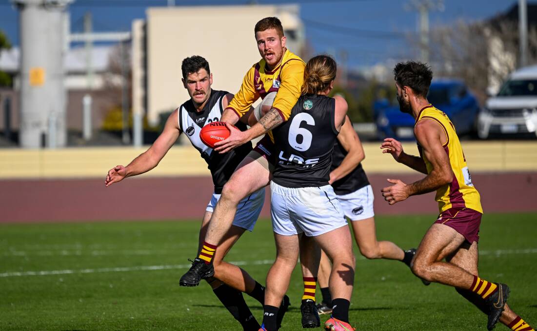 The NWFL's Matt Elliott is tackled by the NTFA's Liam Davies at Devonport Oval on Saturday. Picture by Katri Strooband 