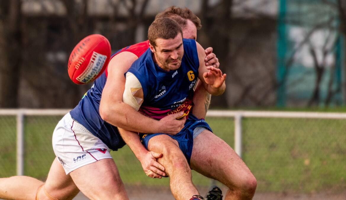 WRAPPED UP: Old Scotch's Matthew Duggan is tackled during his team's loss to Lilydale at the NTCA Ground on Saturday. Pictures: Phillip Biggs 