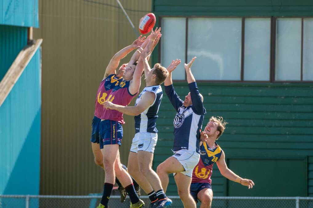 AERIAL BATTLE: Old Scotch and Old Launcestonians players fly for the ball at the NTCA ground.