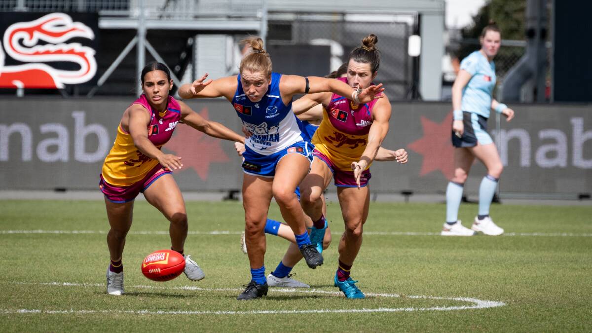 North Melbourne's Mia King competes with Brisbane's Courtney Hodder and Cathy Svarc for the ball at UTAS Stadium in September. Pictures by Paul Scambler 