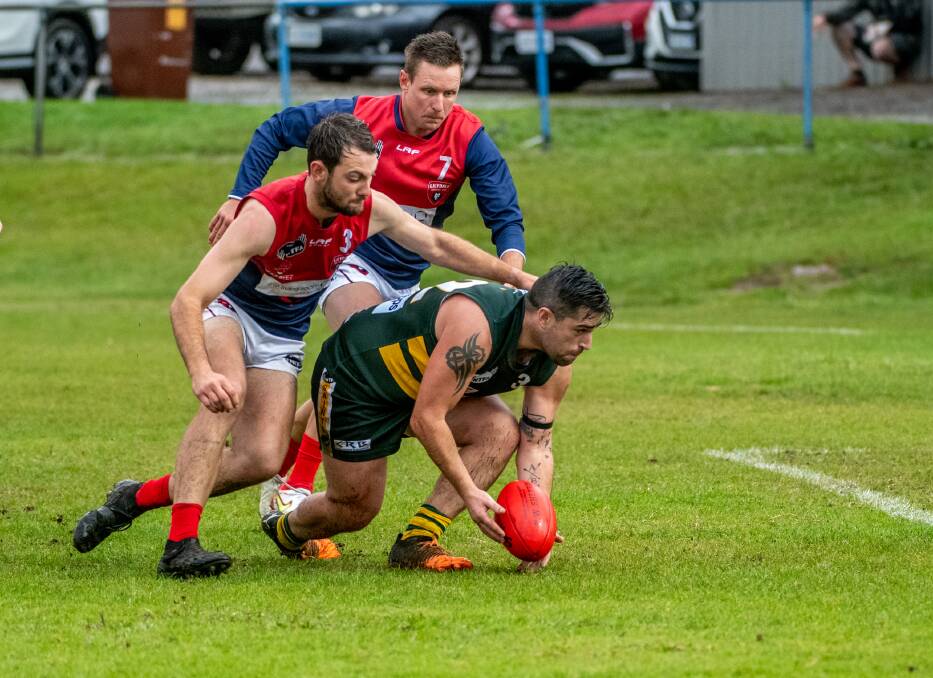 GROUND BALL: St Pats' Ben Arkless under pressure from Lilydale's Jarrod Foale and Sonny Whiting. Picture: Paul Scambler