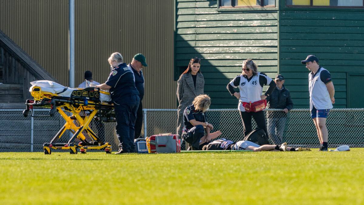 INJURY: Perth playing-coach Danny Bennett receives medical attention during the round-four Perth versus Old Scotch game at the NTCA ground.