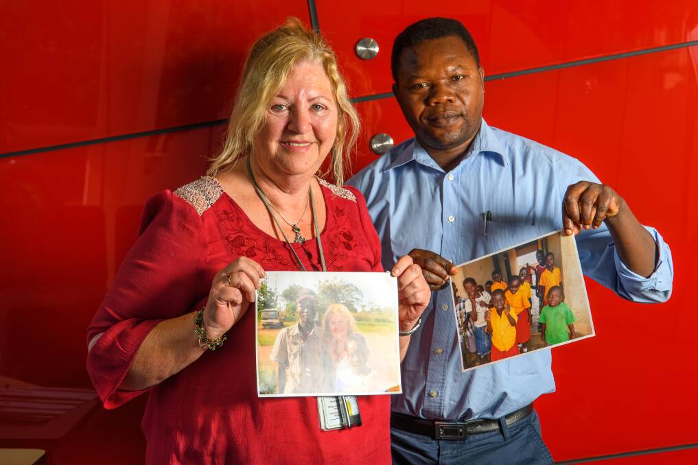 Support: Susan Neighbour and Juma Piri Piri with photos of children sponsored through Young Seeds, a Launceston-based charity. Picture: Scott Gelston