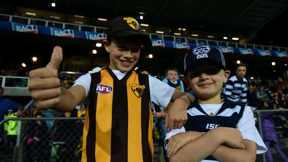 Go Hawks, go Cats: Ewan Pfeffer, 9, and his brother Nate Pfeffer, 6, at the JLT series Hawthorn vs Geelong match at UTAS Stadium on Friday night. Picture: Paul Scambler