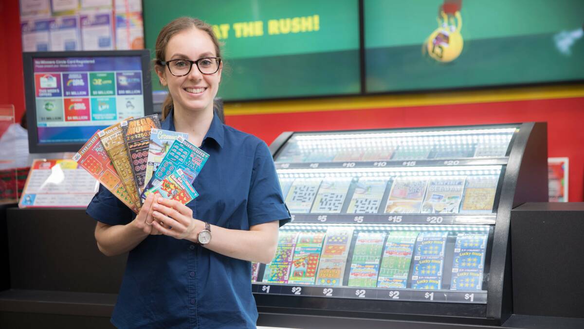 A newsagent worker with Instant Scratch-Its tickets after a Tasmanian woman won big. Picture: Supplied