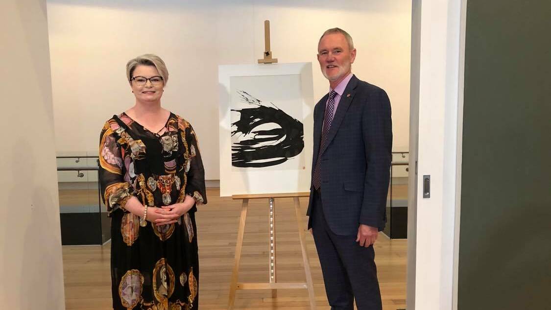 QVMAG General Manager of Creative Arts and Cultural Services Tracy Puklowski and Launceston mayor Albert van Zetten with Brett Whiteley's Waves V.