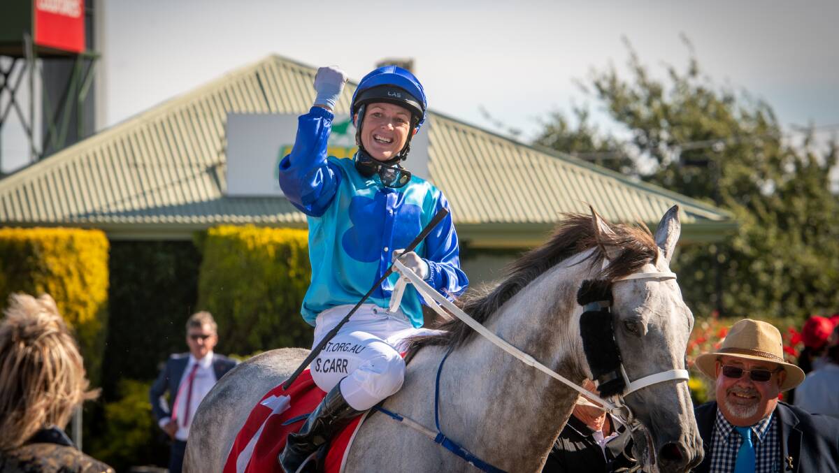 ECSTATIC: Jockey Siggy Carr shows her elation as she returns on Glass Warrior after the narrowest of wins in Wednesday's Launceston Cup. Pictures: Paul Scambler