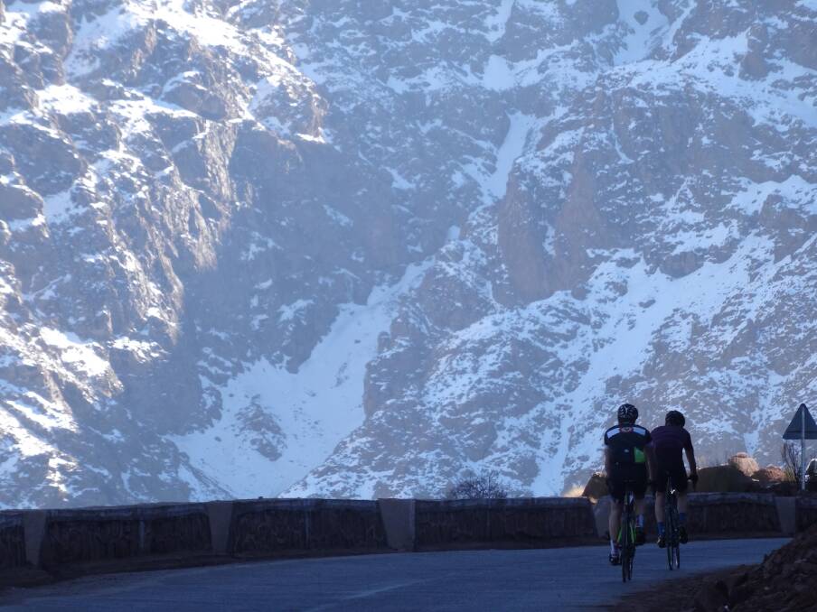 Cycling Morocco's Atlas Mountains: scenery includes snow-capped peaks.