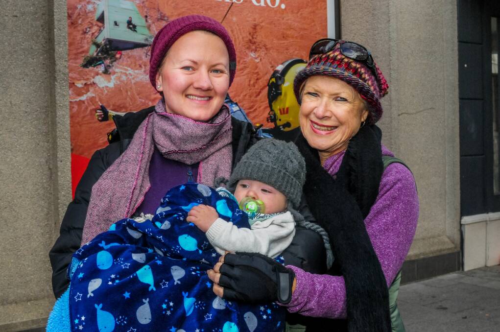 RUGGED UP: Queenslanders Emma Jeffrey, five-month-old Alexander and Deb Jeffrey rug up on a cold winter's day. Picture: Neil Richardson