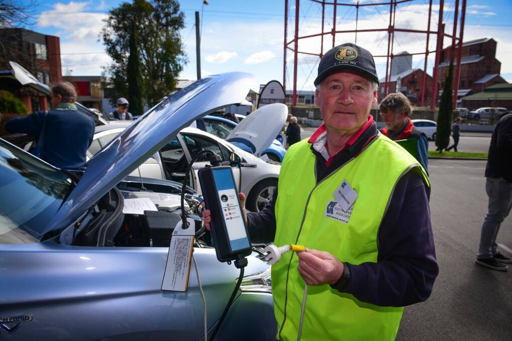ELECTRIC: Australian Electric Vehicle Association of Tasmania member Ray Johnston with his s electric Mitsubishi Outlander. Picture: Neil Richardson