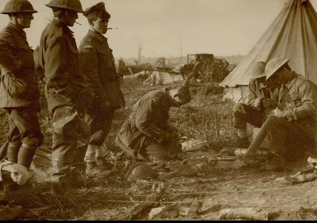 The crew clean their Lewis Gun at Dragoon Farm near Ypres after the Battle of Passchendaele. Pictured are Sergeant H.R. Donaldson, Private H. O'Toole, Private O.H. Molross, Private F. Gale, Lance Corporal A.E Foster and Sergeant George Henry Waller. Picture: Supplied