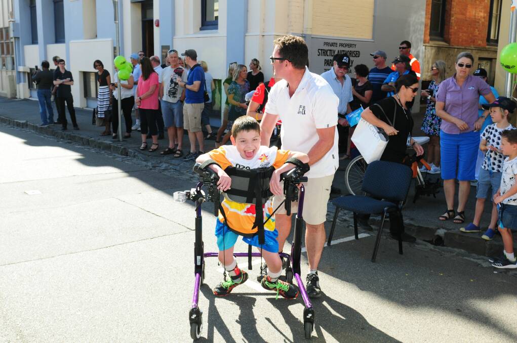 RELAY: Jack Duffy with his father Chris. Jack was chosen to take part in the Queen's Baton Relay in the lead-up to the 2018 Commonwealth Games. Picture: Paul Scambler 