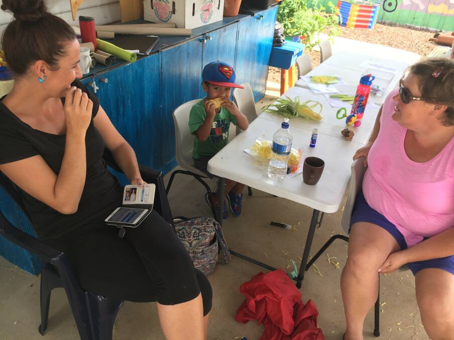 HOMEGROWN: Alyse Natoba, Lemeki Natoba and Natalie Bosworth trying some corn grown at the community centre. Picture: Supplied