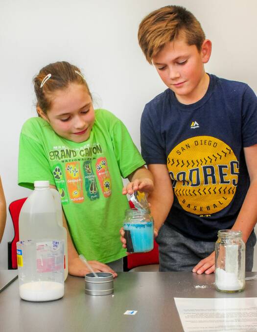 STORM: Millie and Kade Sather making a snowstorm in a jar for one of the experiments. Picture: Neil Richardson 