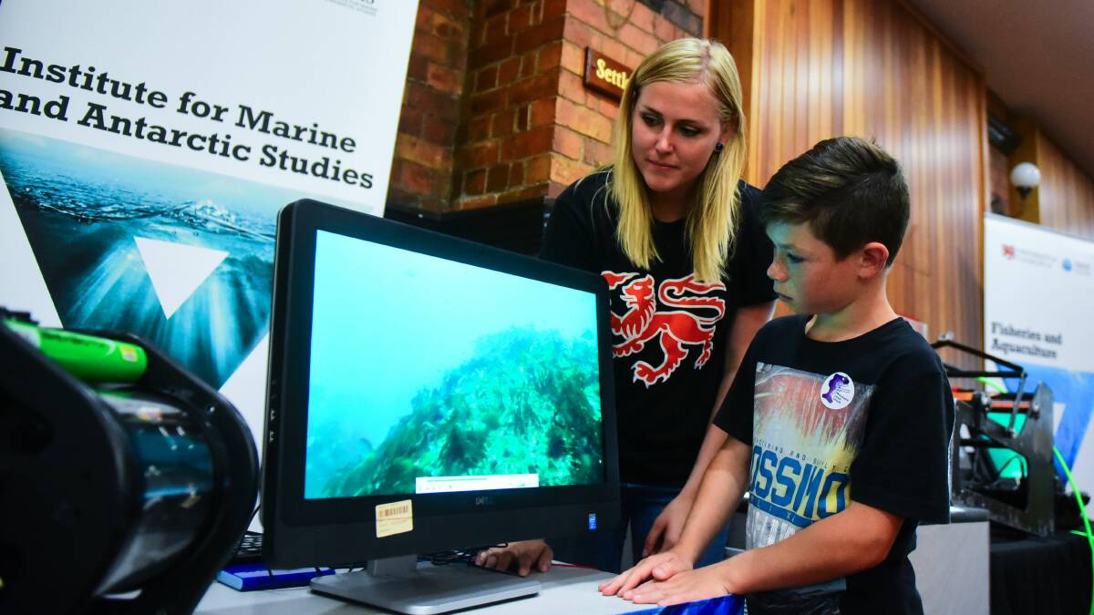 UTAS: IMAS Phd candidate Darryn Sward shows Charlie Quill some of her work. Picture: Neil Richardson