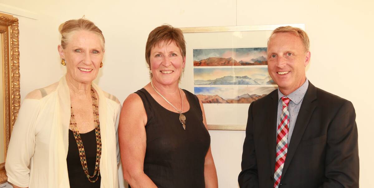 FIRST PRIZE: Meander Valley councillor Deborah White, artist Pauline Winwood and Meander Valley mayor Craig Perkins with the award winning painting Three Tiers. Picture: Supplied