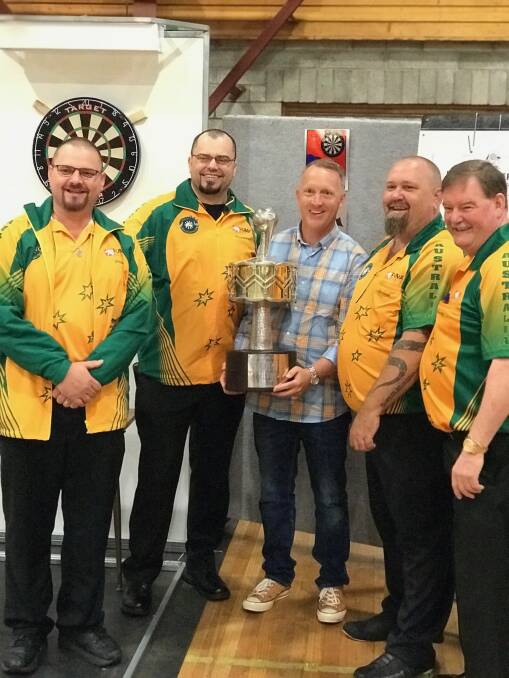 CHAMPS: Australian World Cup darts team Peter Machin, Raymond Smith, Andrew Townes and Rod Bessell and Meander Valley mayor Craig Perkins with the darts world cup. Picture: Supplied