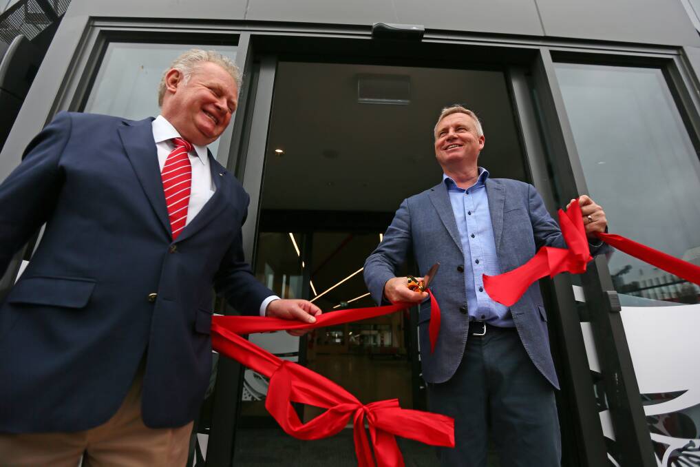 With a helping hand from TT-Line chairman Mike Grainger, Premier Jeremy Rockliff cuts the ribbon to officially open the new Spirit of Tasmania terminal.