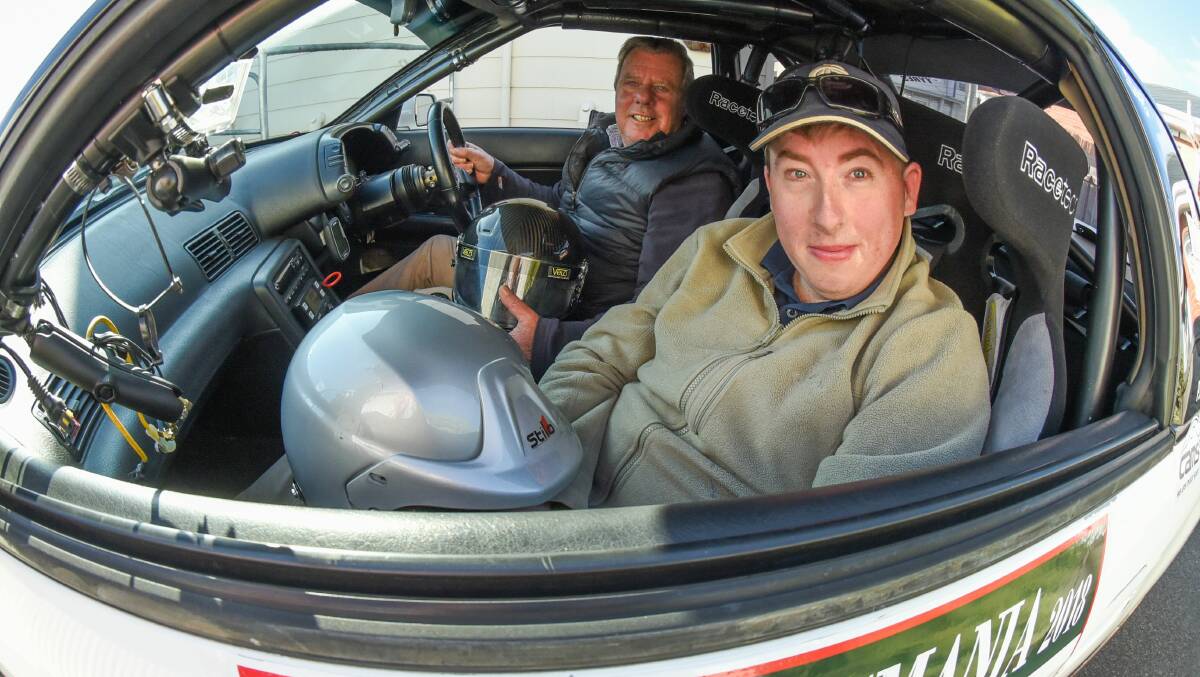SPECIAL SEAT: Peter "Golly" Roberts shows the interior of his 1992 Nissan Skyline to Harald Tanner from Able Australia's Young Adult Program. Picture: Paul Scambler