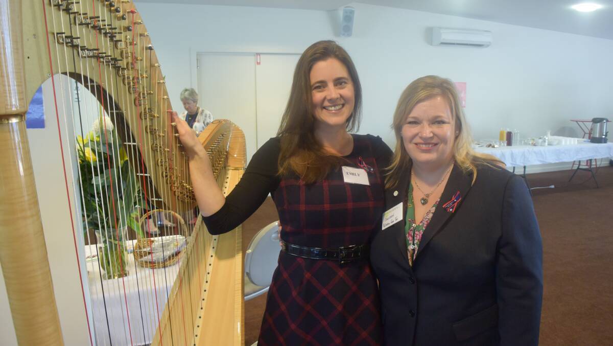 Harpist Emily Sanzaro and Palliative Care Tasmania chief executive Colleen Johnstone.