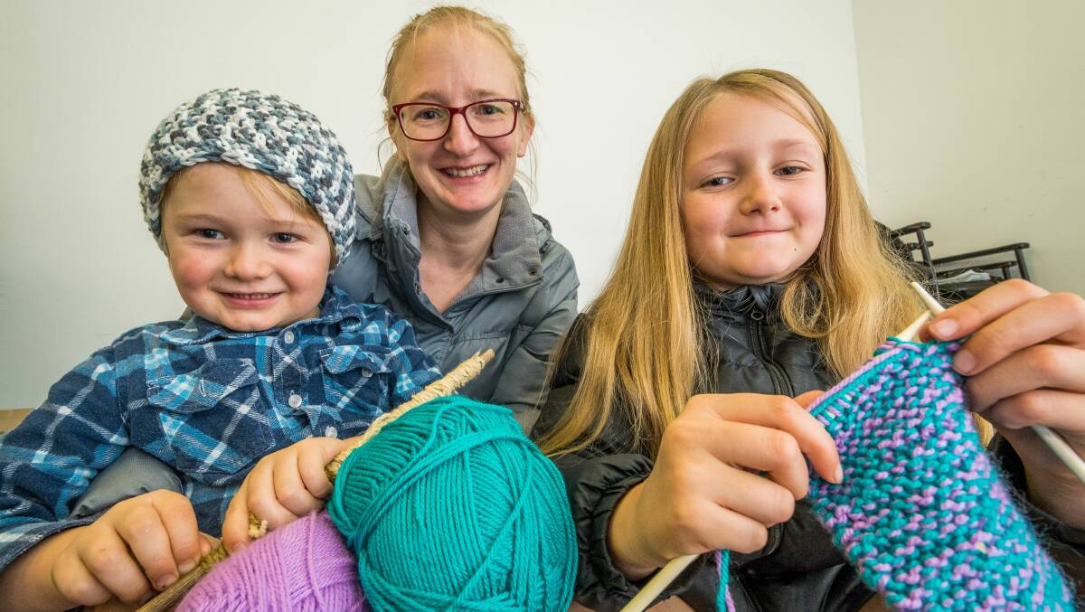 NEEDLEWORK: Samantha Buchanan, of Trevallyn, with Sebastian, 4, and Amelia, 8, with their knitting at Door of Hope. Picture: Phillip Bigg