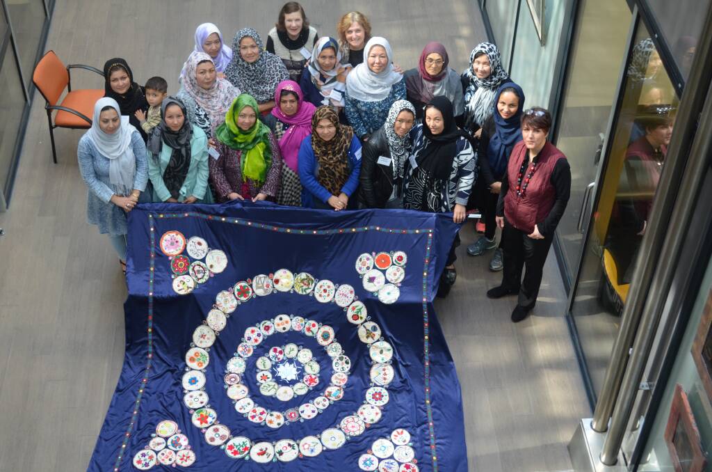 CLOTH CREATION: Members of the Women's Friendship Group with the circular table cloth they designed for display at Northern Integrated Care Services. Picture: Sean Slatter