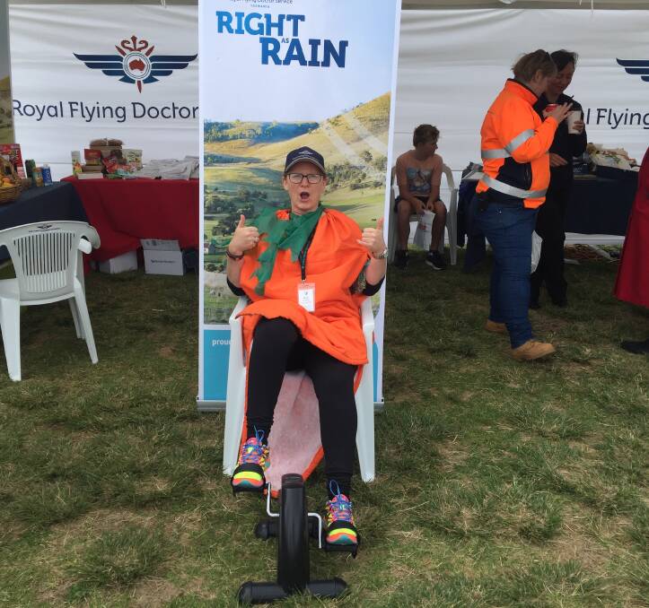 SHOW TIME: Kate Cross of Rural Health Tasmania tries the seated exercise bike at the RFDS site. Picture: Contributed.